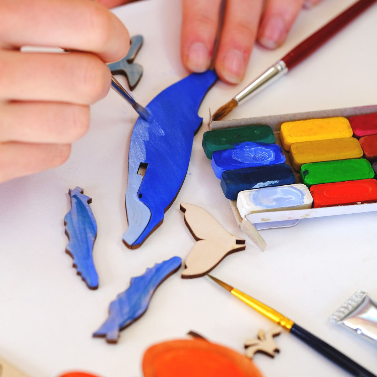 Hand painting the whale and wooden animals from Pop Out Projects craft kits