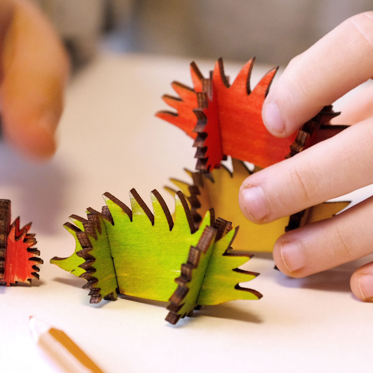 Painted wooden hedgehog craft kit being played with by a child