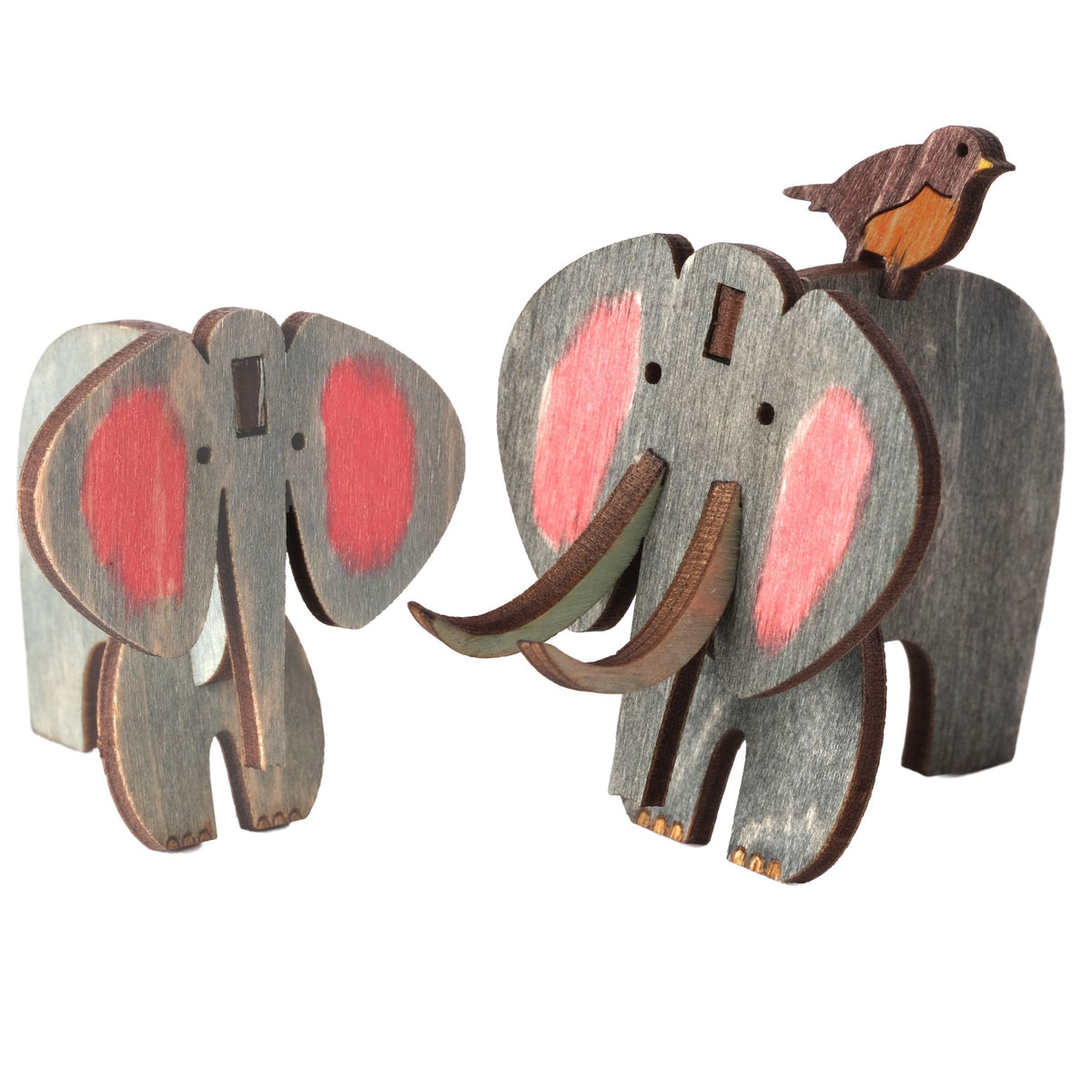 Two painted wooden elephants, one large with tusks and one small, with a little bird, built from the Elephant Wooden Craft Kit
