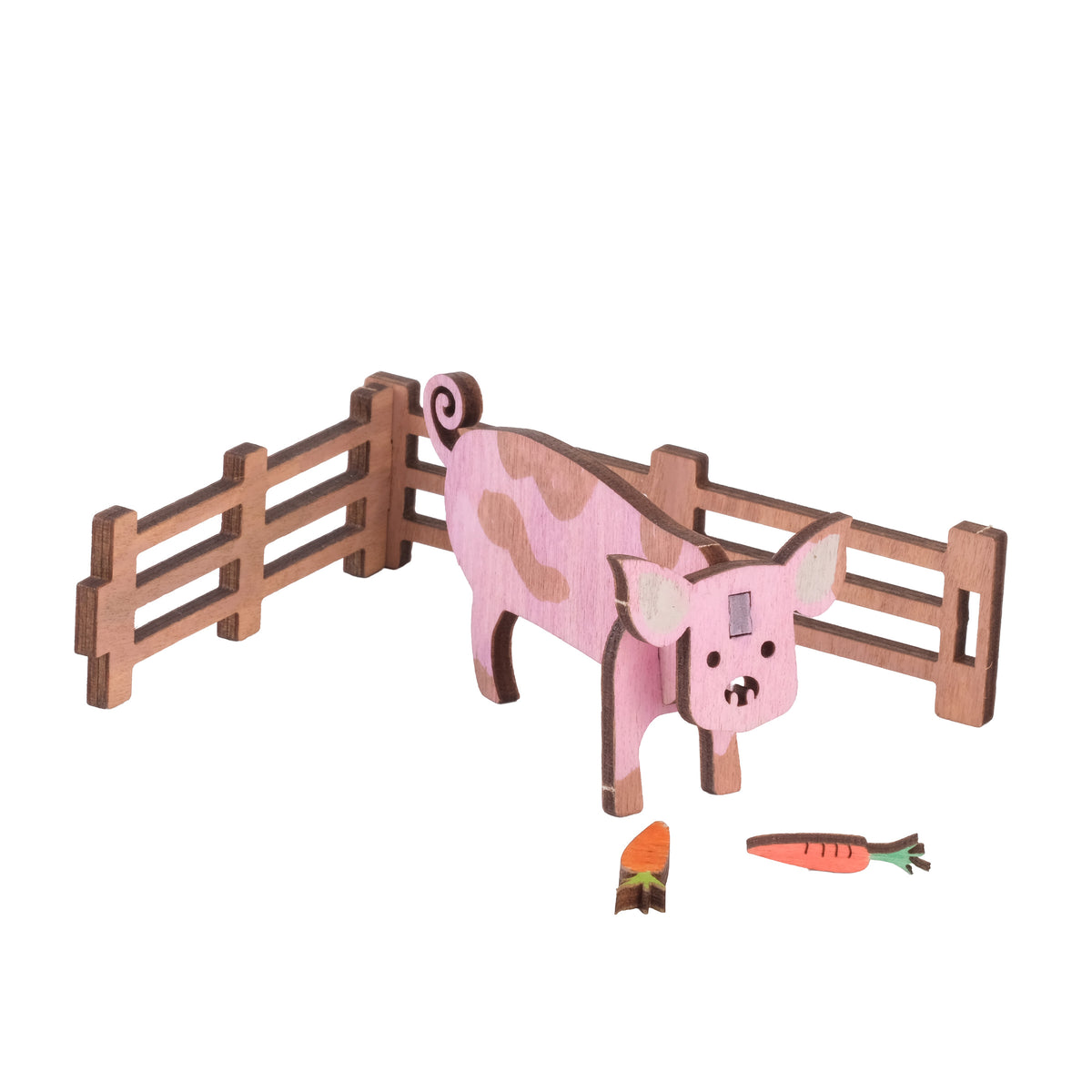 Painted wooden pig with fencing and wooden carrots, built from the Pig Wooden Craft Kit